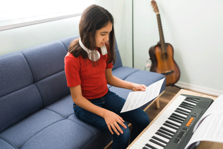 kid playing keyboard beautiful girl reading piece sheet music learning how play piano while practicing her music lessons living room 768x512